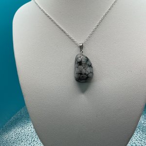 Beautiful patterned gray agate stone featuring natural layered textures and soft gray tones, polished gemstone with unique organic banding.