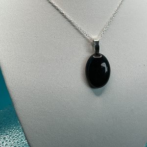 Black glitter stone necklace with a polished sparkling dark pendant on a delicate chain, elegant fashion gemstone jewelry piece for women.